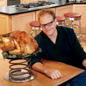 Person posing with a roasted turkey from Owl Creek Farm on a large spring in a kitchen setting.