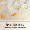 Close-up of a bowl of Frog Eye Salad with a printed label on the glass by Owl Creek Farm.