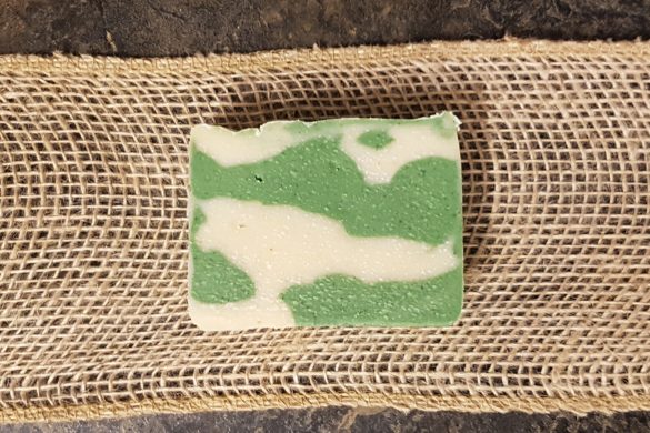 The Applejack soap by Owl Creek Farm rests elegantly on burlap against a dark background.