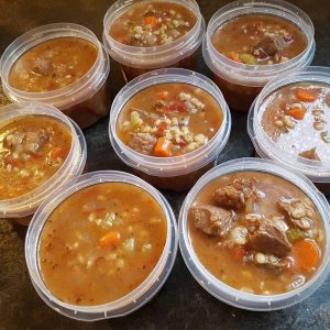 photo of beef and barley stew in plastic containers for freezing